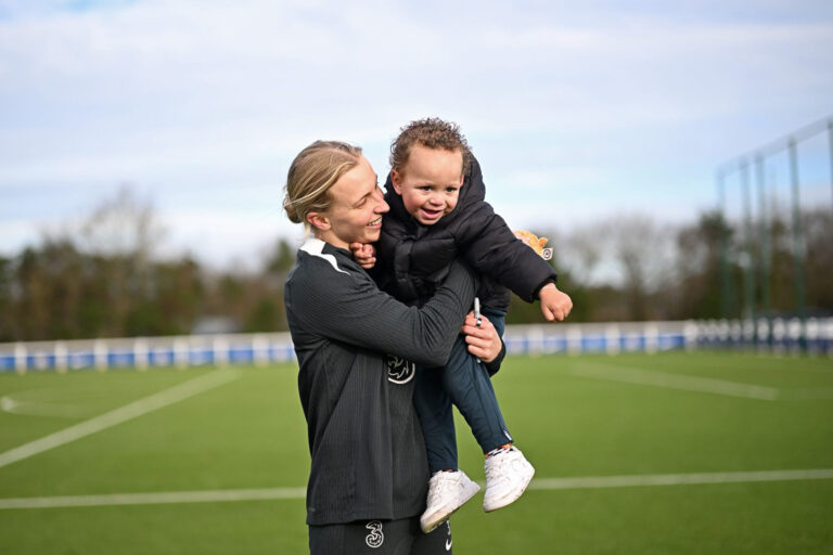 A child supported by Momentum meeting a Chelsea Women's player during a visit to the club's training ground.