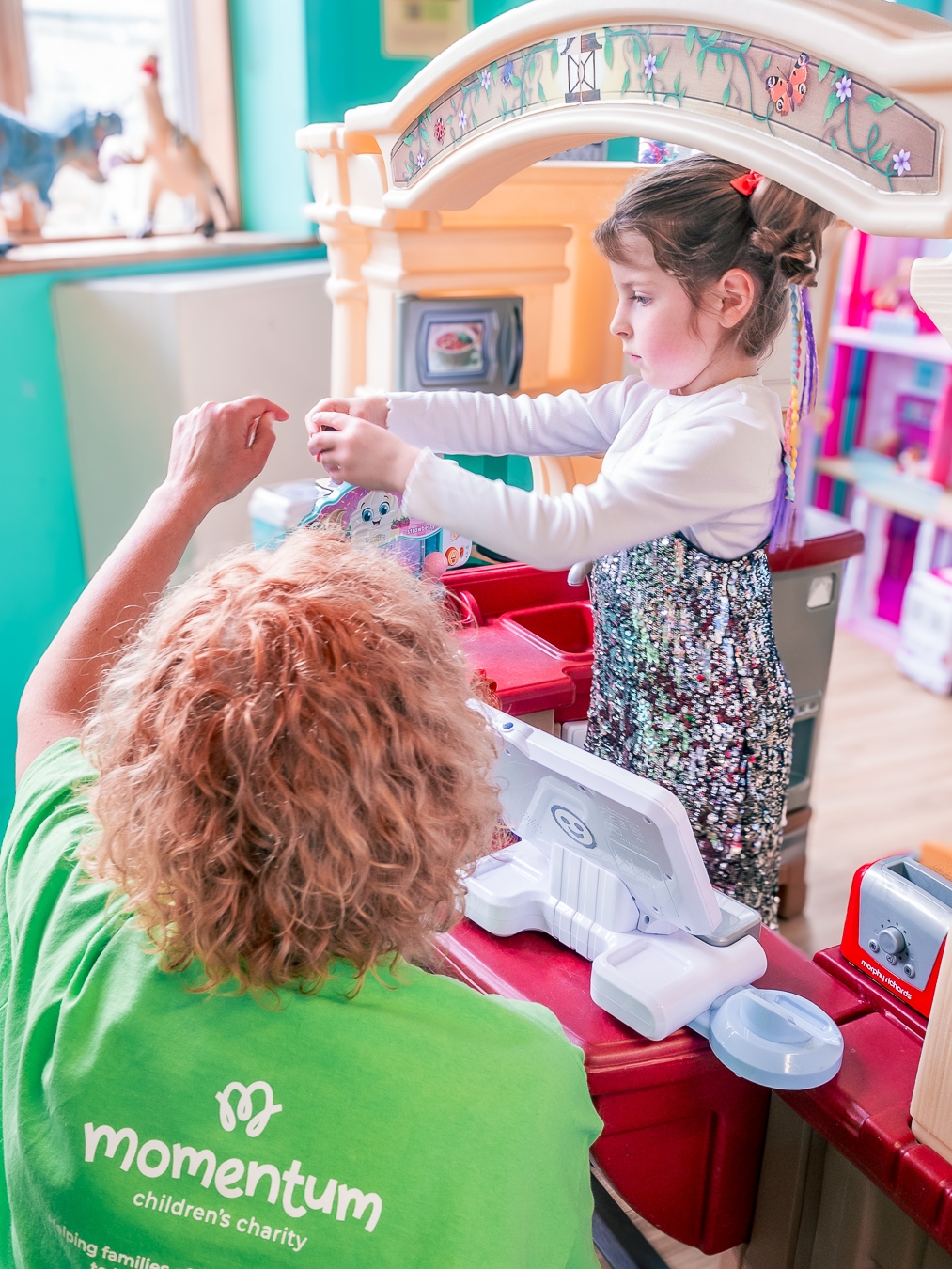 A child playing with Momentum's CEO during a hospital visit.