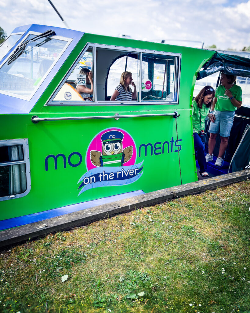 The Momentum Children's Charity boat moored at a marina.