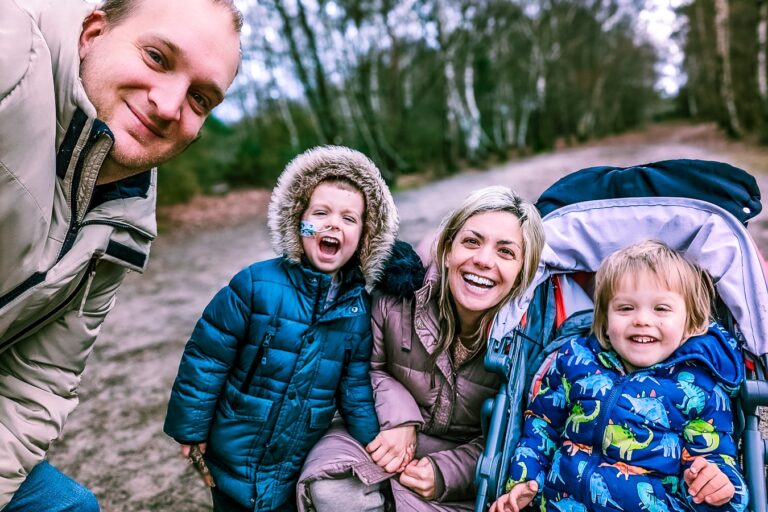 A supported family photographed together on an autumn walk during a respite break.