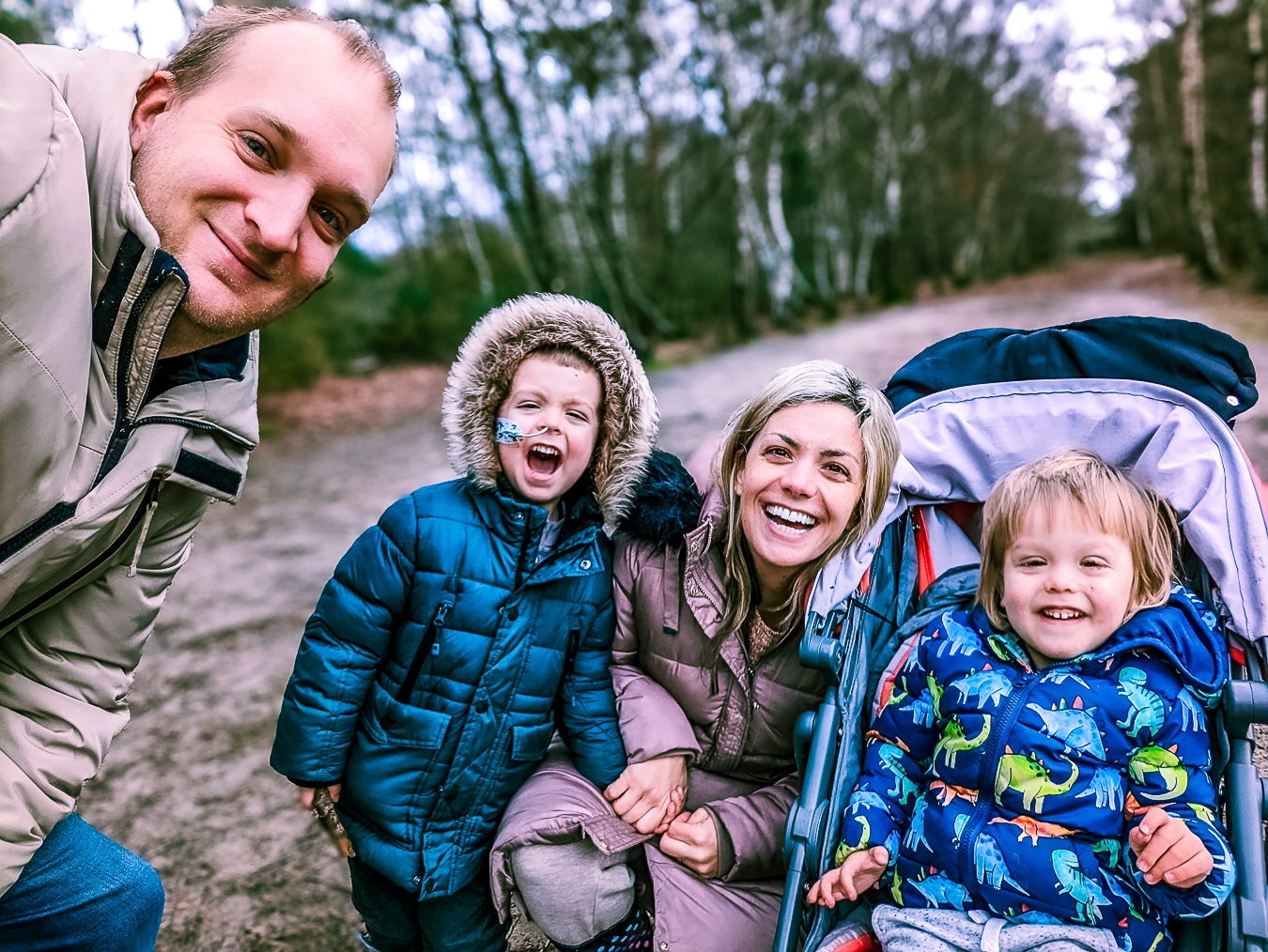 A supported family photographed together on an autumn walk during a respite break.