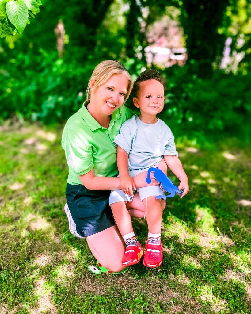 A supported child and Family Support Worker together at the marina during a Momentum family event day.