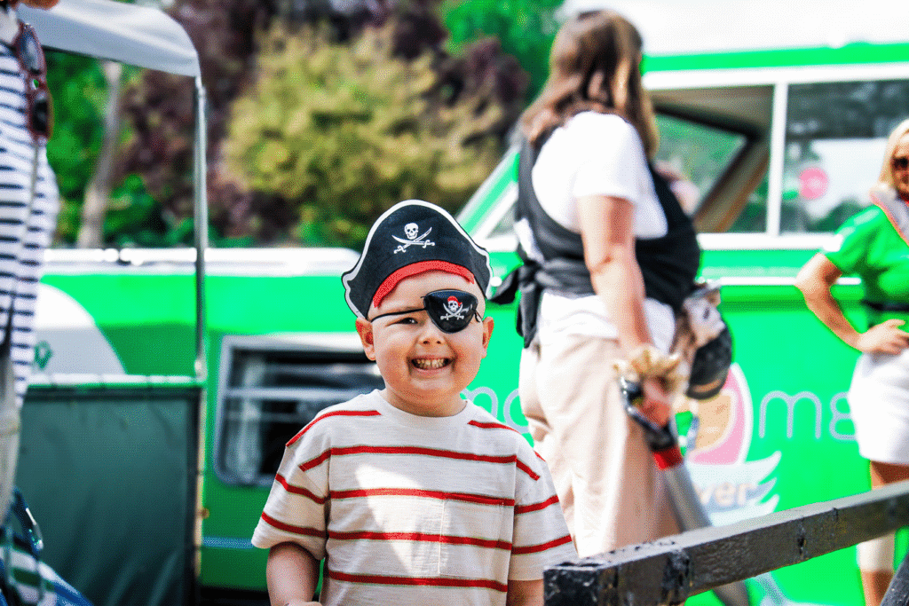 Young boy dressed as a pirate on a Momentum Children's Charity boat trip at Shepperton Marina.