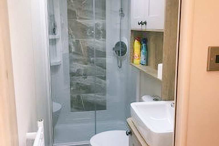 Modern walk-in shower room inside the Momentum Children's Charity family respite cabin.