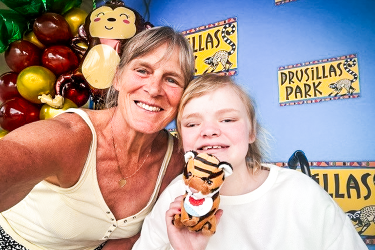 A woman and a young girl smile together at Drusillas Park