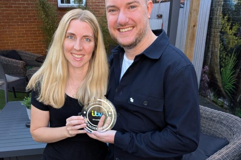 An Echoes-supported Dad, together with his wife, proudly holding his 'Pride of Britain' award outside in the garden.