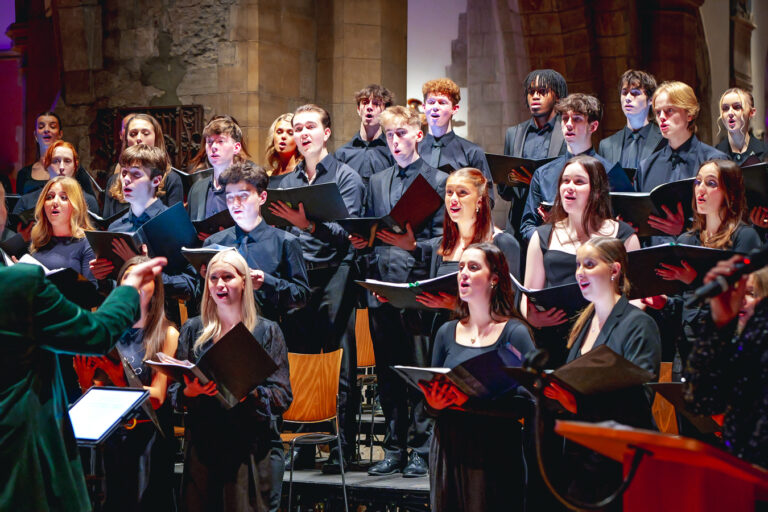 A choir sings inside a church at a charity event