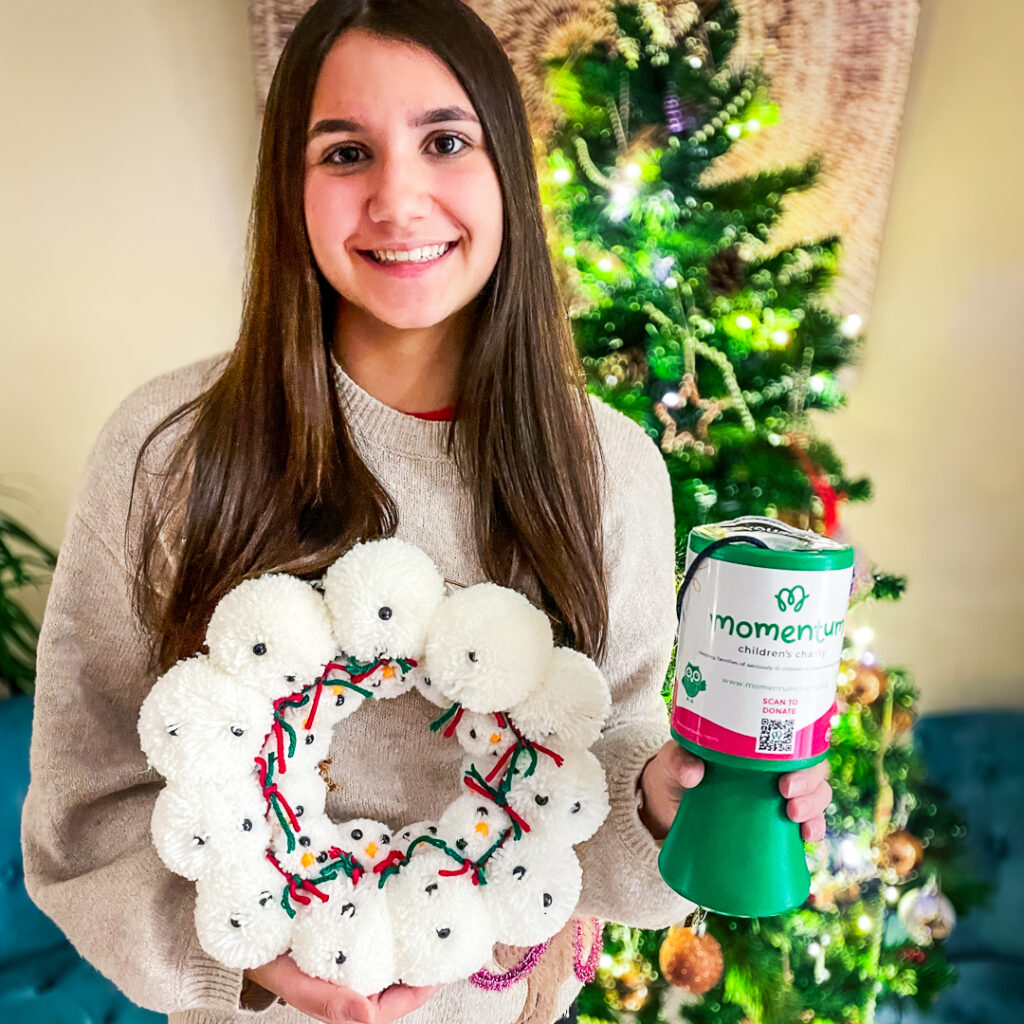 A young momentum supporter holds an Christmas appeal for families