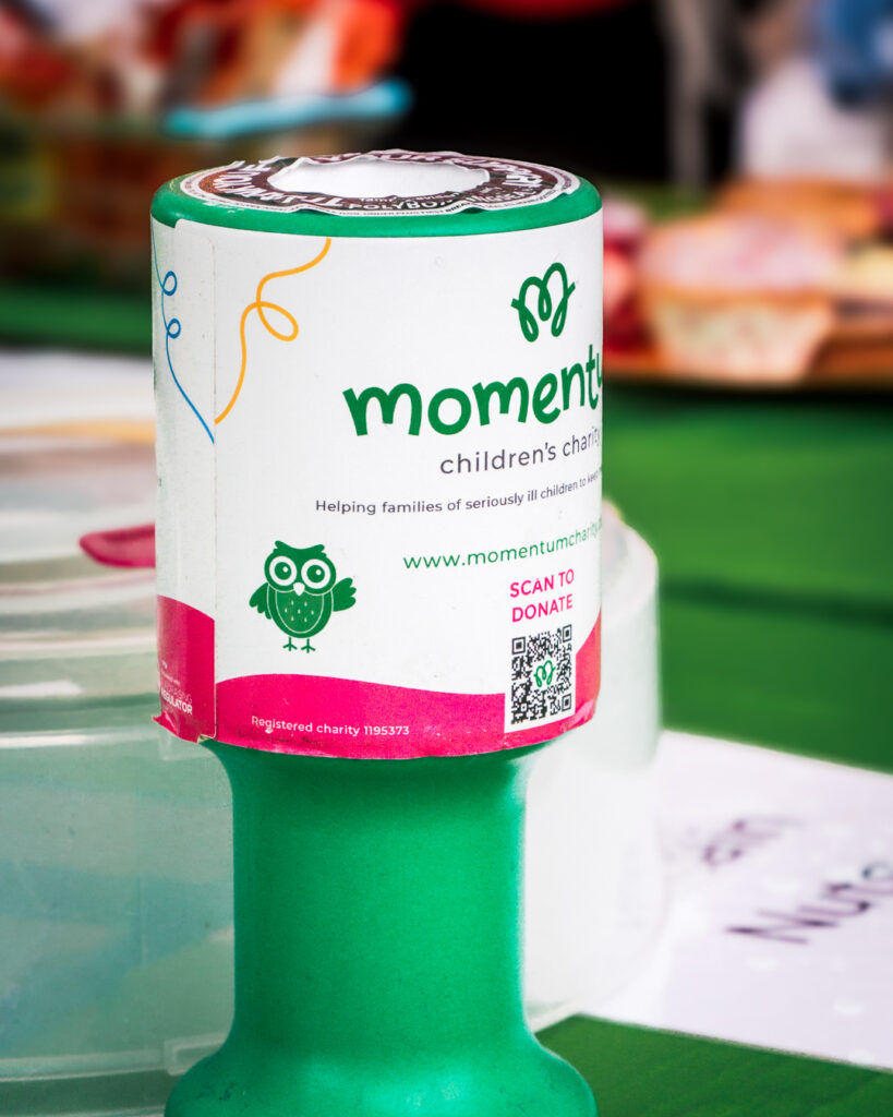 A close up image of a Momentum donation jar at an event.