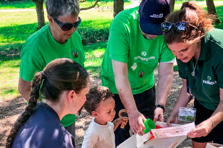 A Momentum supported family with volunteers from the charity and a Painshill Park member of staff