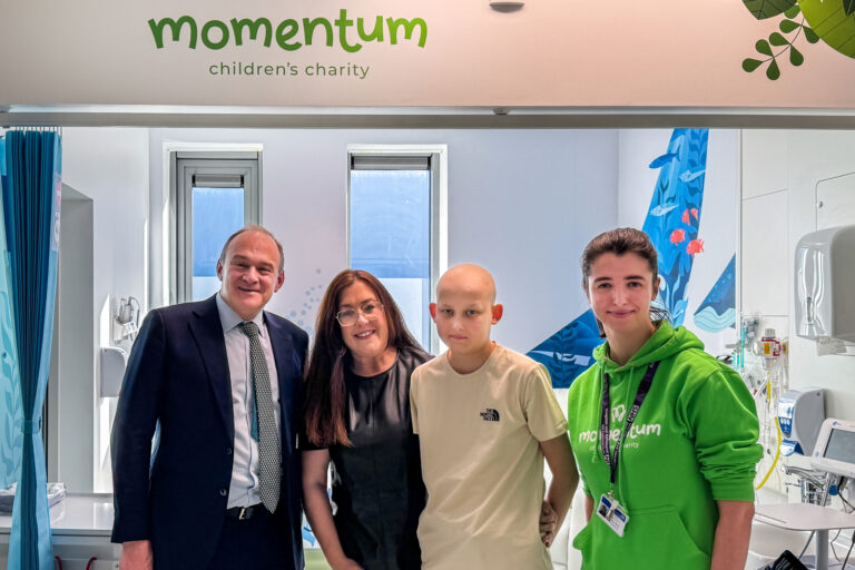 MP Ed Davey poses with a Momentum supported family and Family Support Worker at Kingston Hospital.