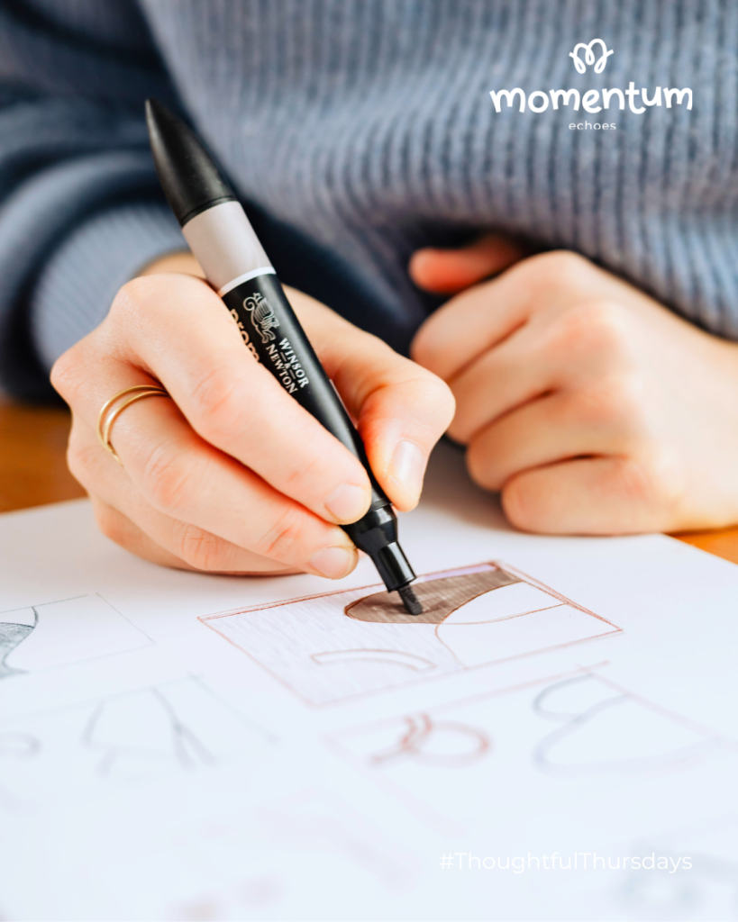 A close up of a person drawing during a creative therapy session