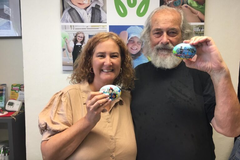 Momentum CEO poses with a pebble painting volunteer to celebrate his 800th pebble milestone.