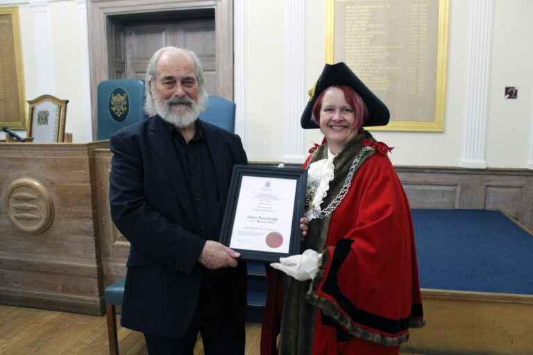 Pebble painting volunteer receives special award from the Mayor.
