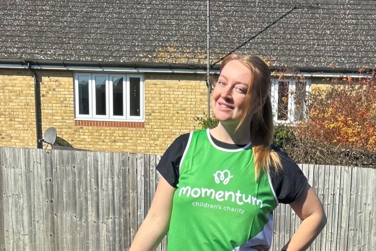 Runner poses in Momentum running top