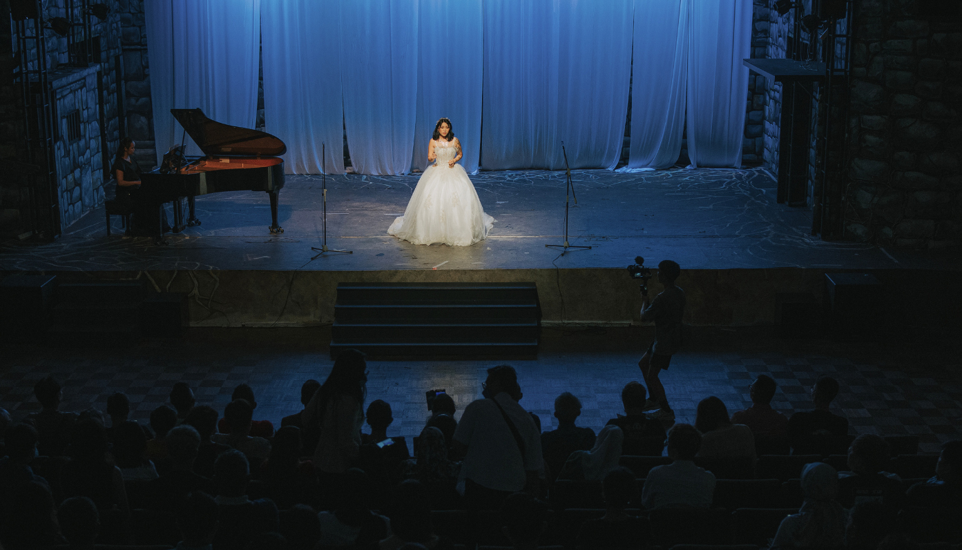 An opera singer performs on stage.
