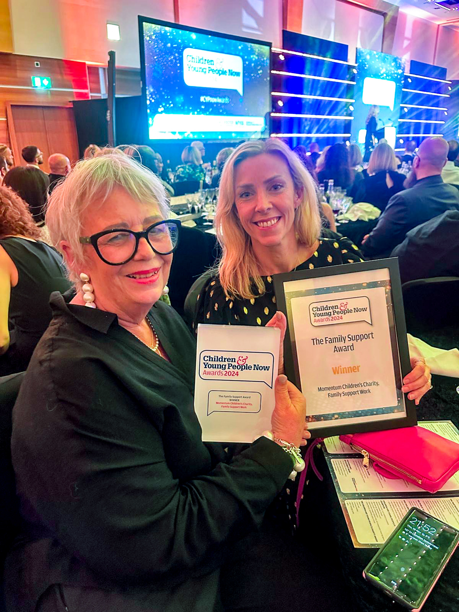 Momentum Children's Charity Founder and Family Support Worker at Children and Young People Now Awards ceremony - smiling and holding the awards.