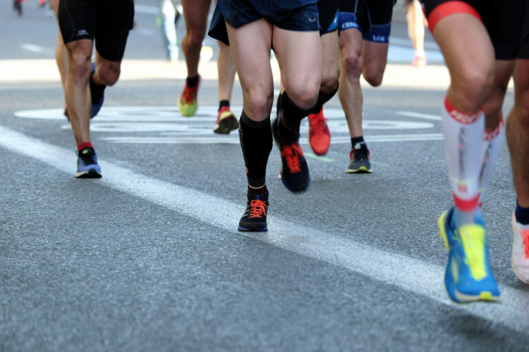 Runners taking part in a road race, representing the running challenges and charity fundraising events you can run for Momentum Children's Charity.