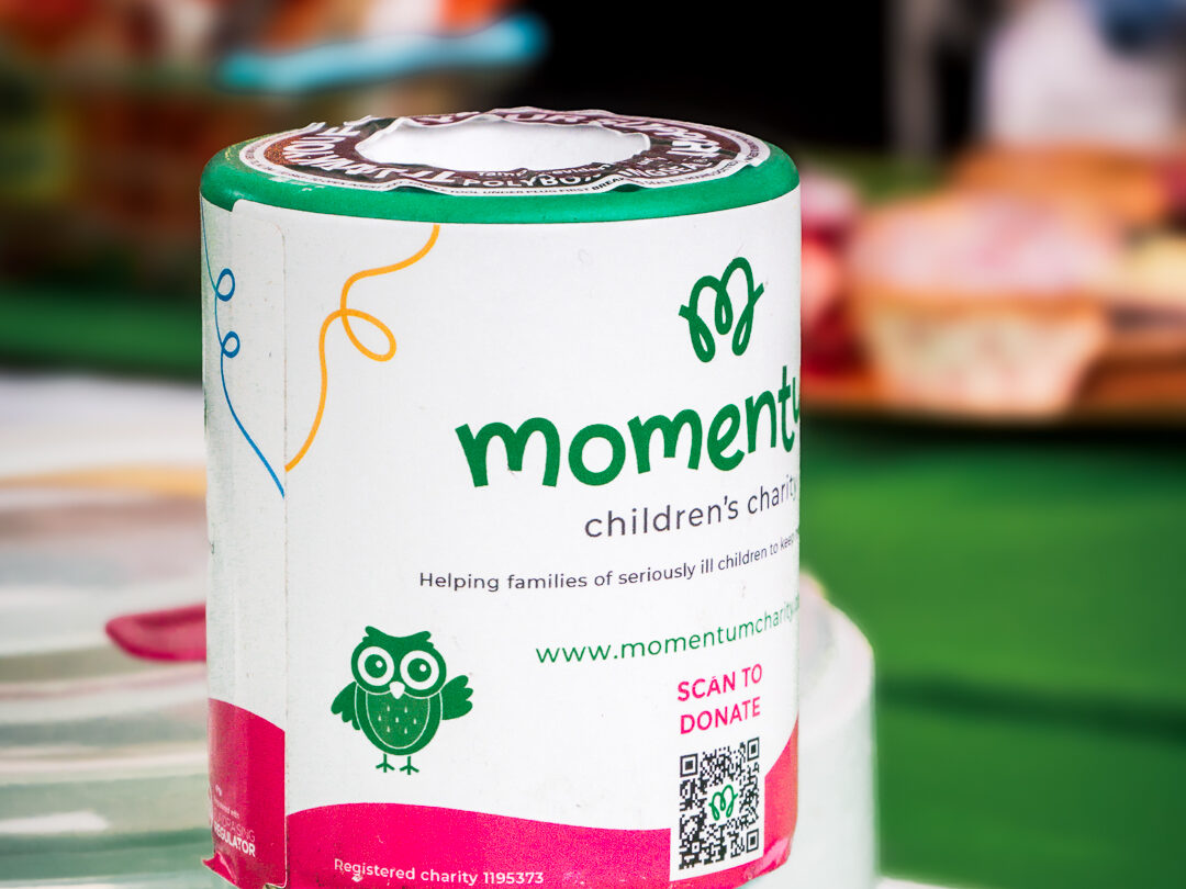 A close up image of a Momentum donation jar at an event.