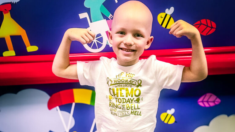A child celebrating his end-of-chemo bell ringing at The Royal Marsden, one of Momentum Children's Charity's partner hospitals.