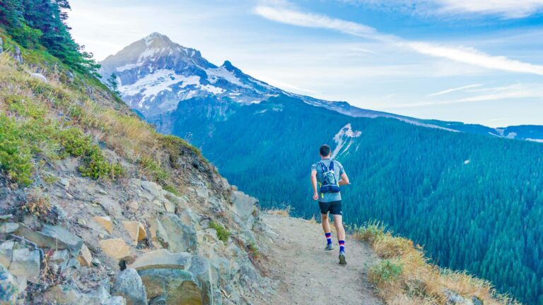 A man wearing a running vest backpack takes part in an ultra trail run.