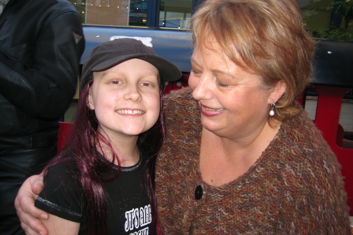 Bianca, Founder and Honary president with a supported child in the early days of Momentum.